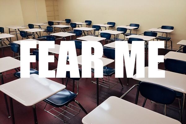 An empty schoolroom full of desks with "FEAR ME" superimposed. cc: https://www.semtrio.com/
